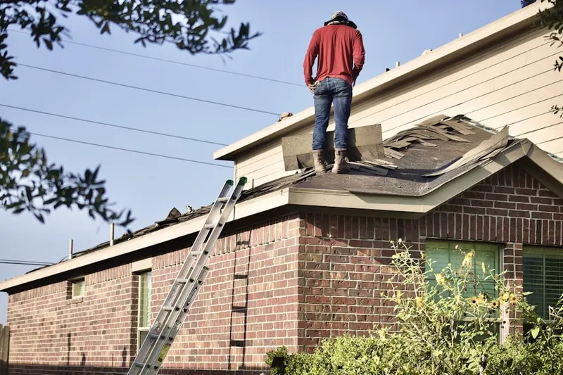 Professional roofer working on a residential roof in Waxhaw